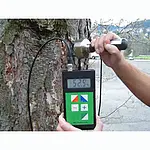 Detector de humedad de madera realizando una medición en un tronco