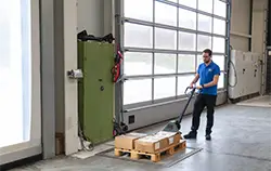 Floor scales in use in an industrial hall during a weighing operation.